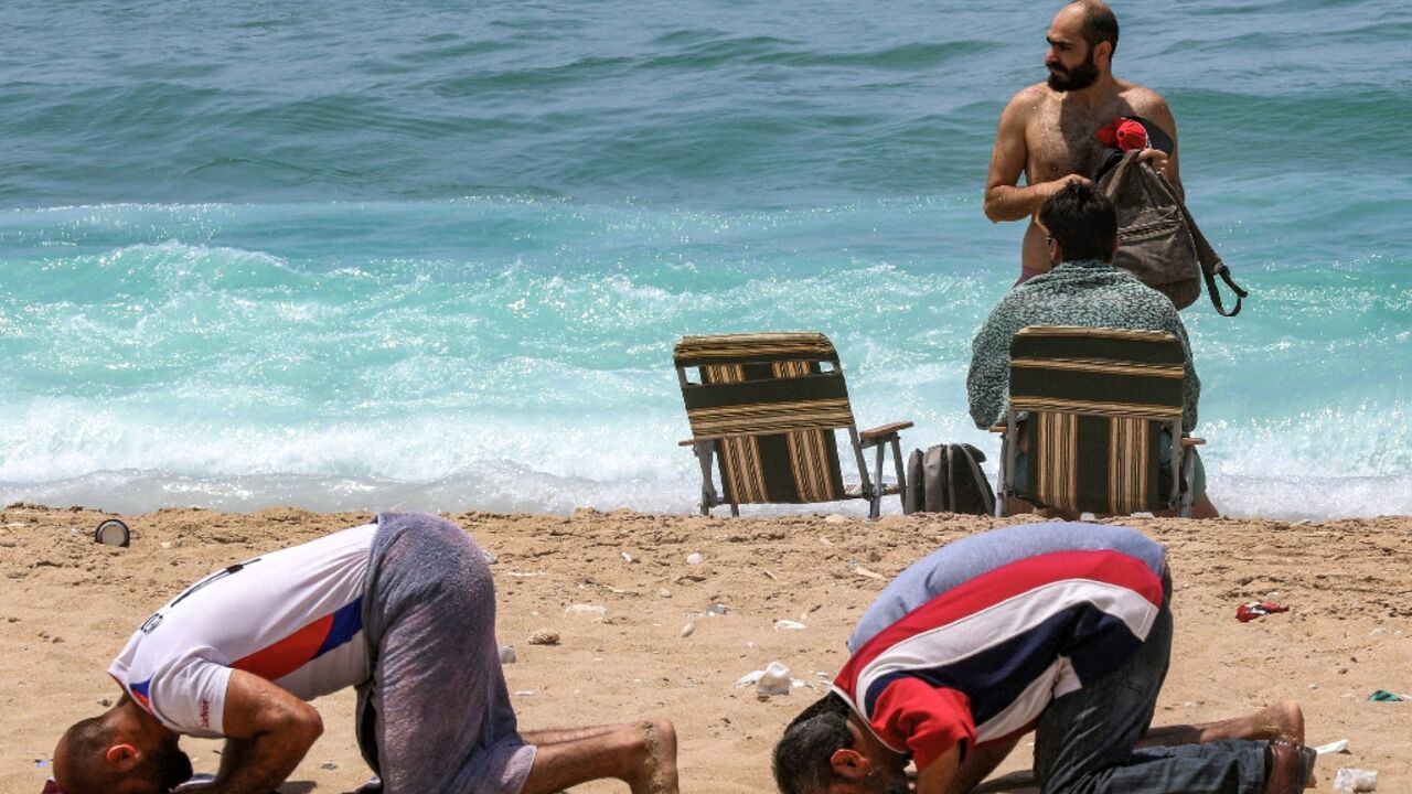 A group of conservative Muslims held prayers at the beach in Sidon as security forces deployed to the area A group of conservative Muslims held prayers at the beach in Sidon as security forces deployed to the area