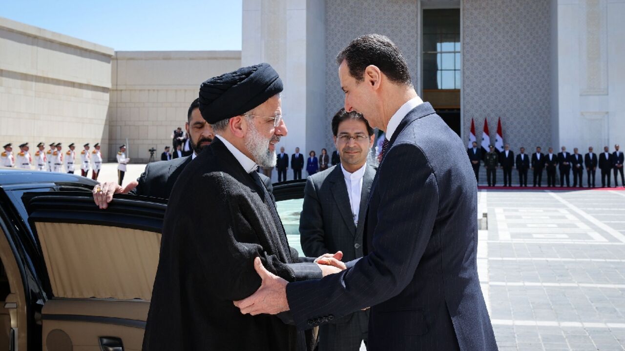 Syria's President Bashar al-Assad, on the right, received his Iranian counterpart Ebrahim Raisi at the presidential palace in Damascus on May 3, 2023