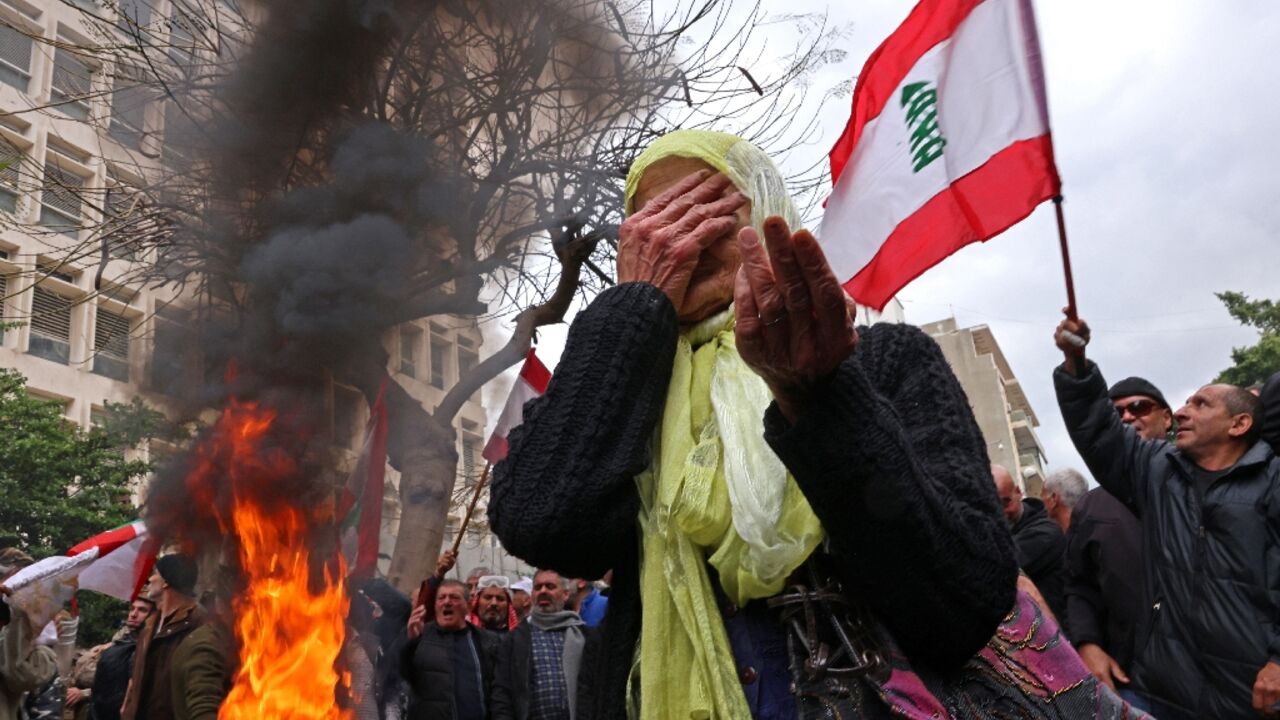 Protesters rally outside Lebanon's central bank headquarters in Beirut on March 30, 2023, demanding pension payments are adjusted to runaway inflation Protesters rally outside Lebanon's central bank headquarters in Beirut on March 30, 2023, demanding pension payments are adjusted to runaway inflation