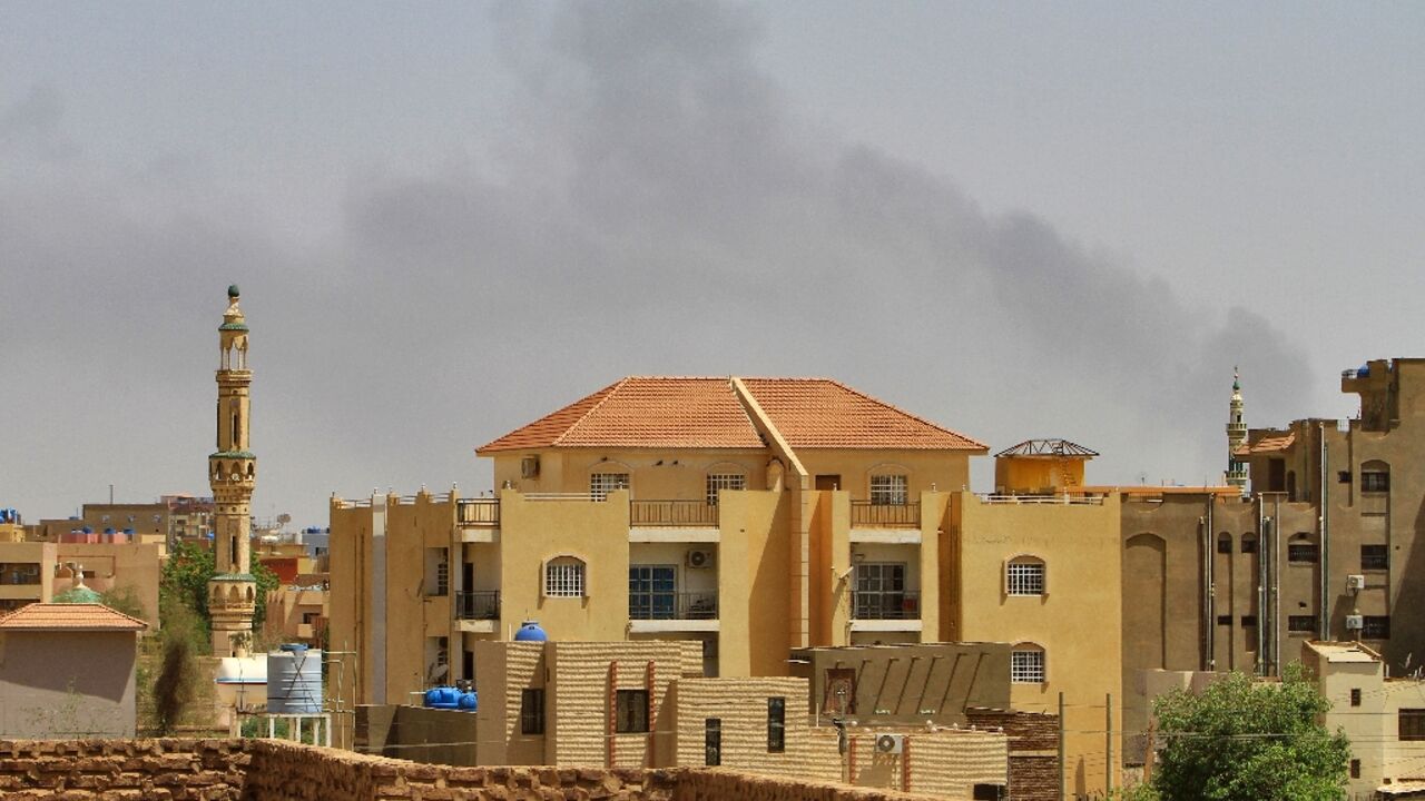 Smoke rises above buildings in Khartoum as fighting between the forces of two rival generals continues