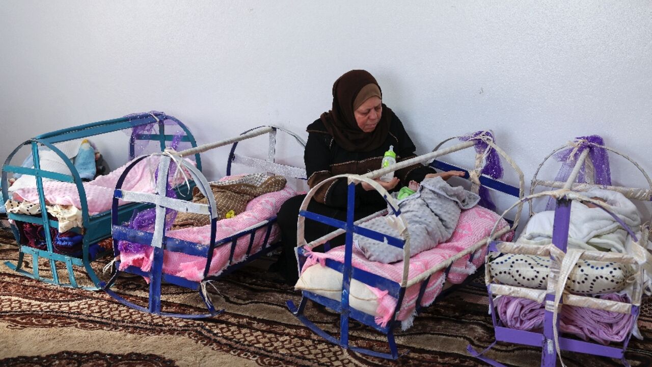 In Syria's rebel-held Idlib province, workers at the main centre for abandoned children tend to babies in basic cradles, some spruced up with purple paint or ribbons