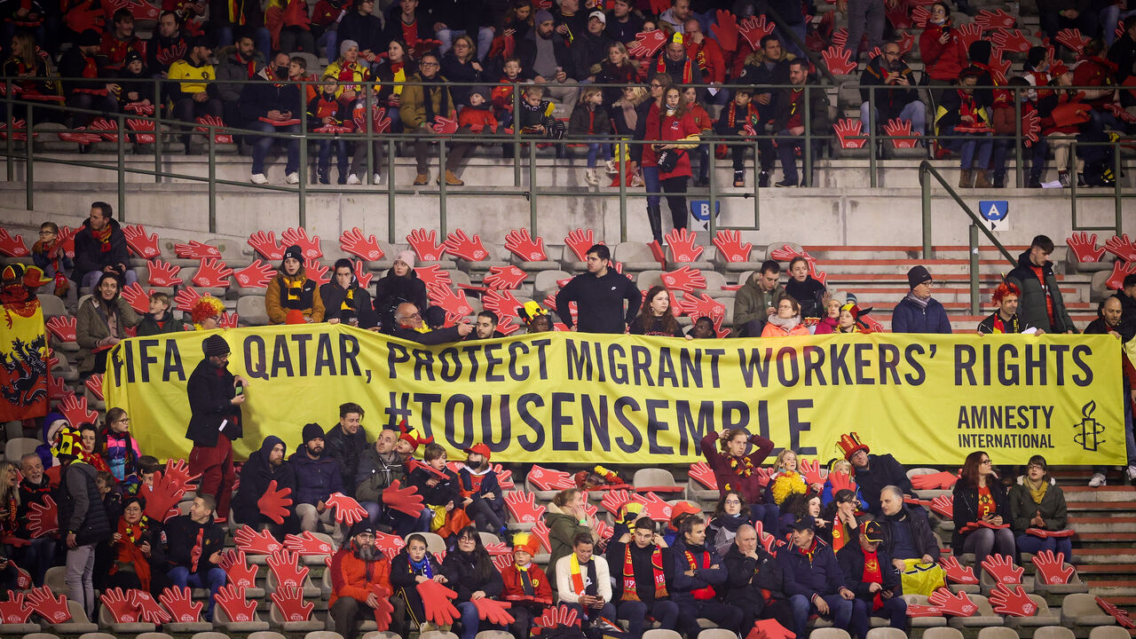 Belgium's supporters with a banner to ask for protection of migrant workers' rights in Qatar.