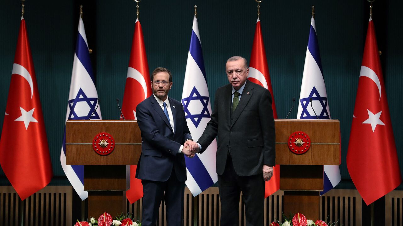 Israeli President Isaac Herzog (L) and his Turkish counterpart Tayyip Erdogan shake hands during a press conference in Ankara, on March 9, 2022. (Photo by AFP) (Photo by STR/AFP via Getty Images)