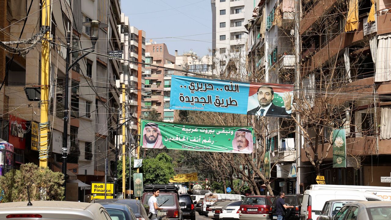 A banner bearing the picture of former Lebanese premier Saad Hariri and a slogan in Arabic which reads "Allah, Hariri, Tariq al-Jdideh" and another depicting Saudi Arabia's King Salman (R) and his son Crown Prince Mohammed with a slogan "Beirut remains Arab despite the haters", hang on a street in the Tariq al-Jdideh neighbourhood of the capital Beirut, on April 27, 2022. - Lebanon's Sunni Muslim community is gearing up for May 15's parliamentary polls without strong leadership for the first time in decades