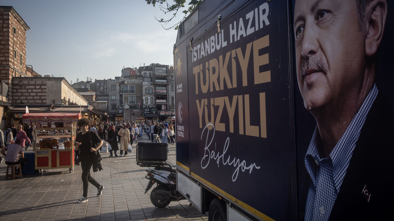 ISTANBUL, TURKEY - MAY 25: People walk past an election campaign poster for Turkey's President Recep Tayyip Erdogan on May 25, 2023 in Istanbul, Turkey. The country is holding its first presidential runoff election after neither candidate earned more than 50% of the vote in the May 14 election. (Photo by Chris McGrath/Getty Images)
