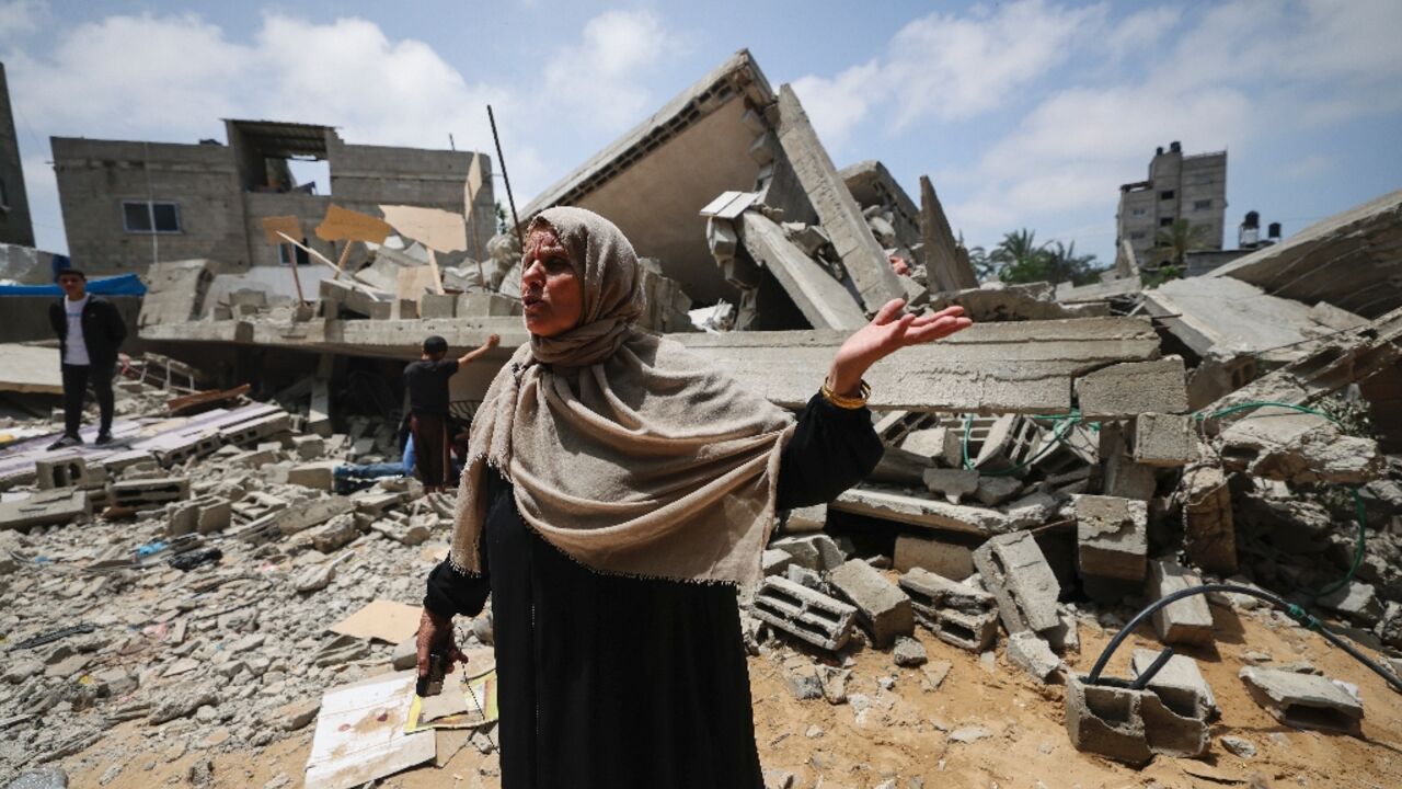 A member of the Palestinian Nabhan family speaks in front of the rubble of the family home, flattened in an Israeli air strike in Beit Lahiya, in the northern Gaza Strip A member of the Palestinian Nabhan family speaks in front of the rubble of the family home, flattened in an Israeli air strike in Beit Lahiya, in the northern Gaza Strip