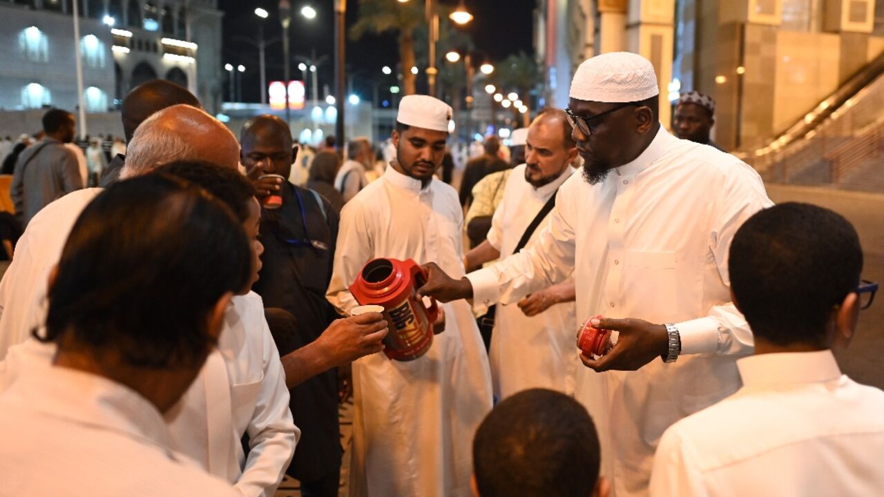 A Saudi family distributes free tea to pilgrims in Mecca for the hajj pilgrimage