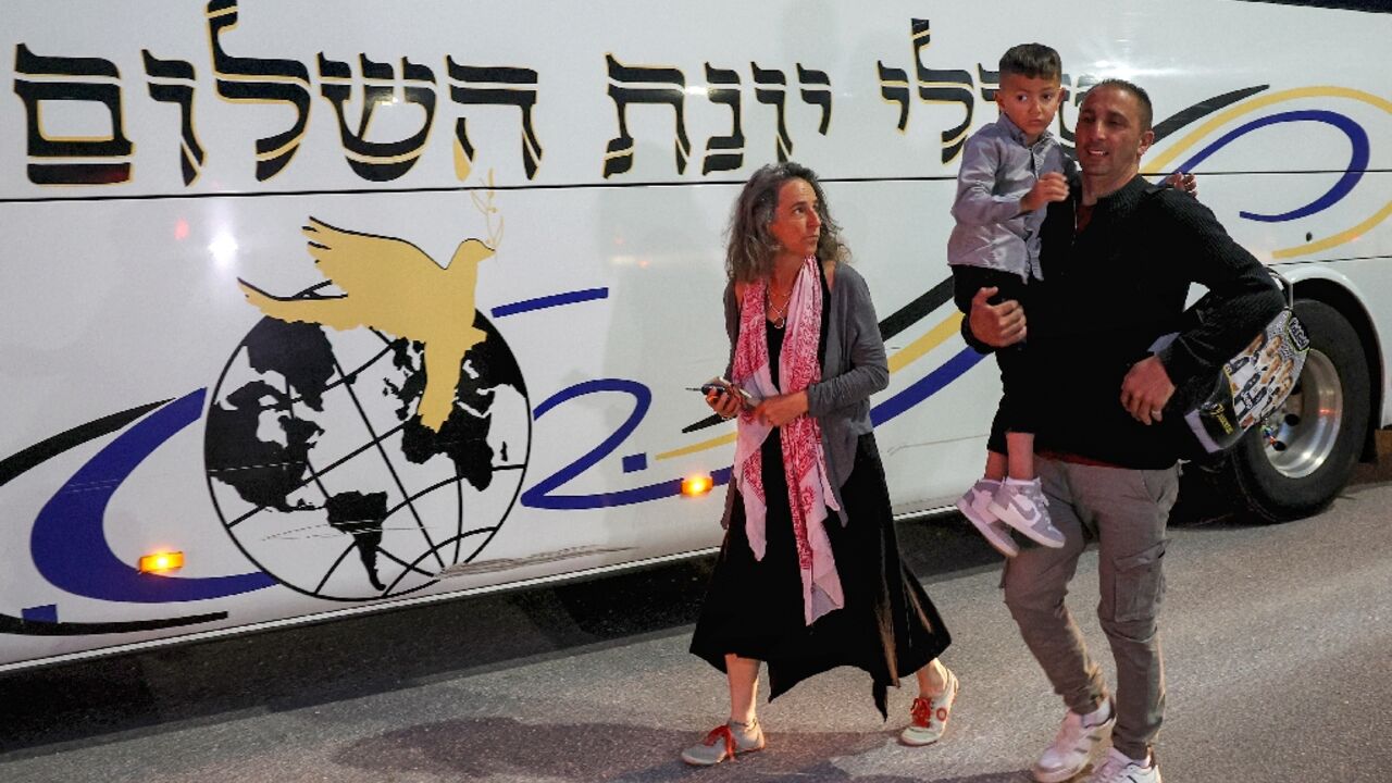 Adam Abu al-Rob, a six-year-old Palestinian eye cancer patient, is carried by his father Mamoun beside Yael Noy, who heads the Israeli charity Road to Recovery Adam Abu al-Rob, a six-year-old Palestinian eye cancer patient, is carried by his father Mamoun beside Yael Noy, who heads the Israeli charity Road to Recovery