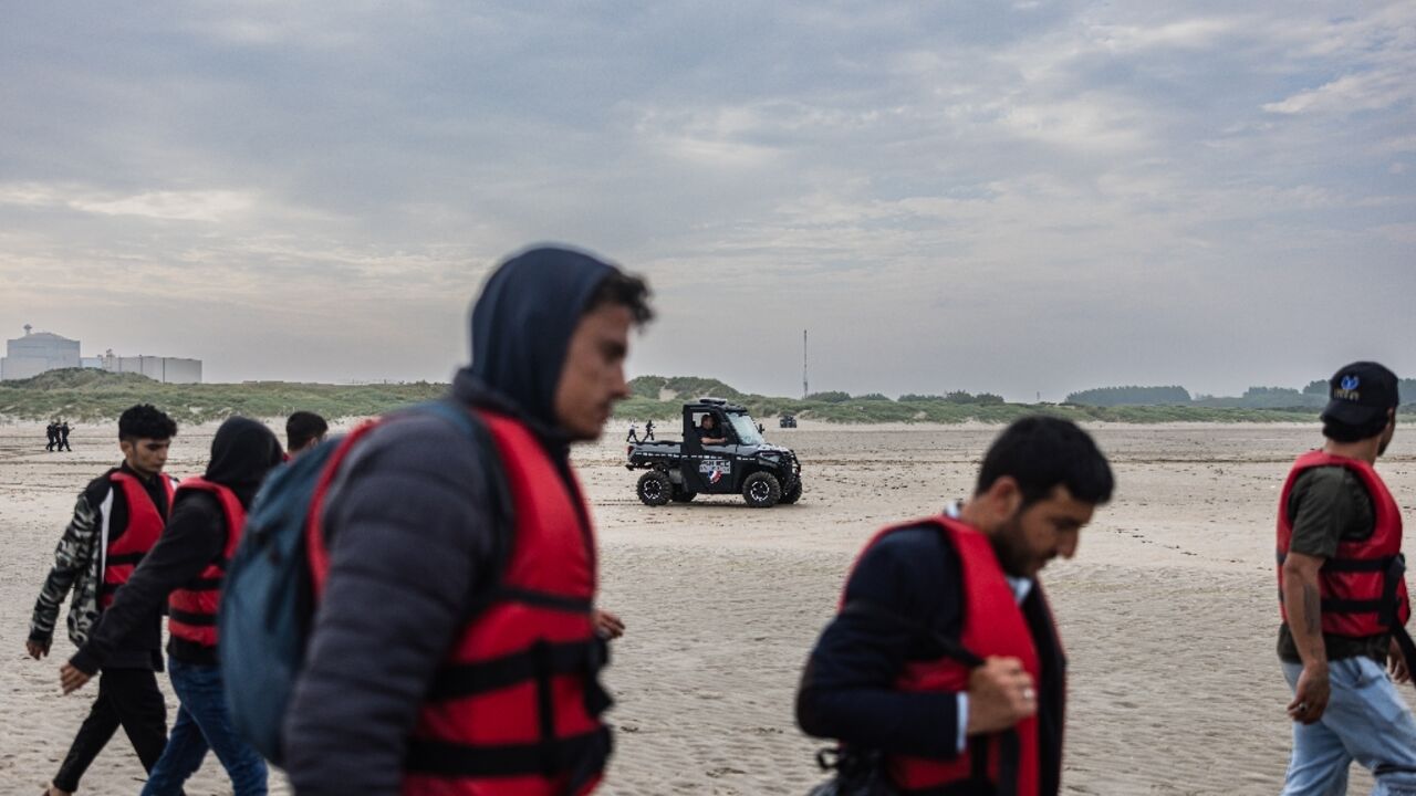 Migrants return inland after being prevented from boarding smugglers' boats by French National Police Migrants return inland after being prevented from boarding smugglers' boats by French National Police
