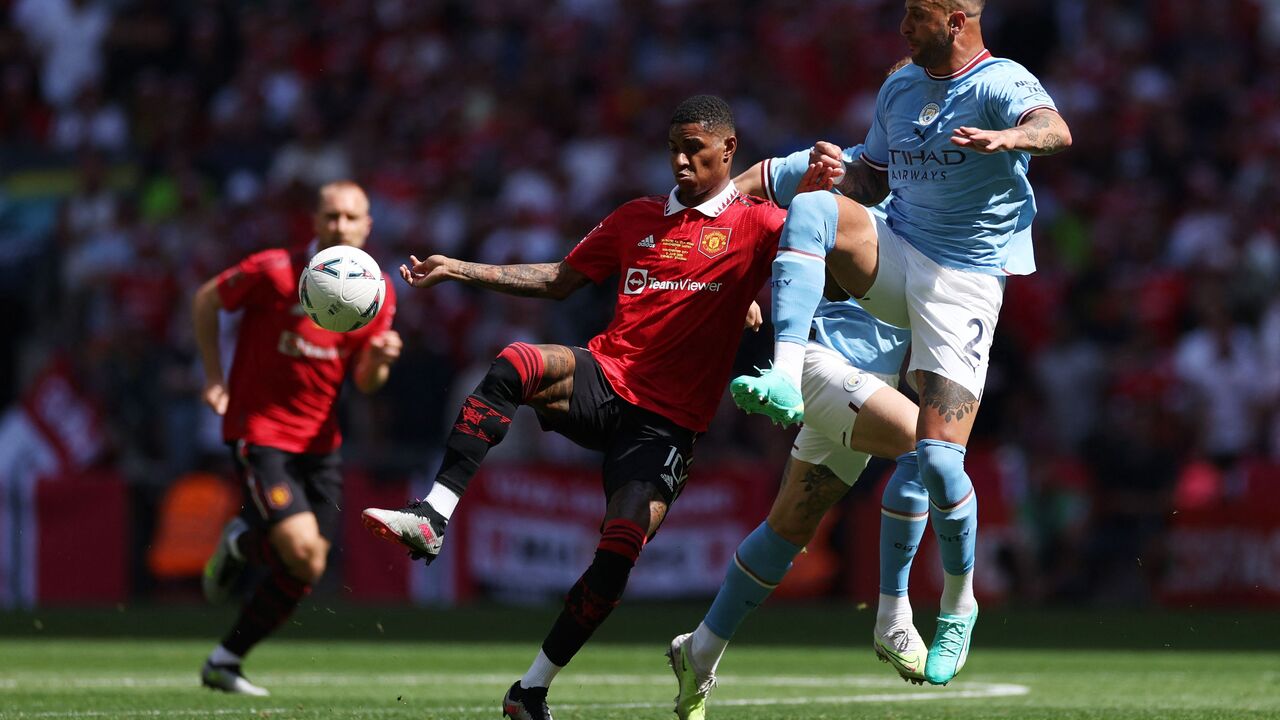 Manchester United's English striker Marcus Rashford (C) and Manchester City's English defender Kyle Walker (R) compete during the English FA Cup final football match between Manchester City and Manchester United at Wembley stadium, in London, on June 3, 2023. (Photo by Adrian DENNIS / AFP) / NOT FOR MARKETING OR ADVERTISING USE / RESTRICTED TO EDITORIAL USE (Photo by ADRIAN DENNIS/AFP via Getty Images)