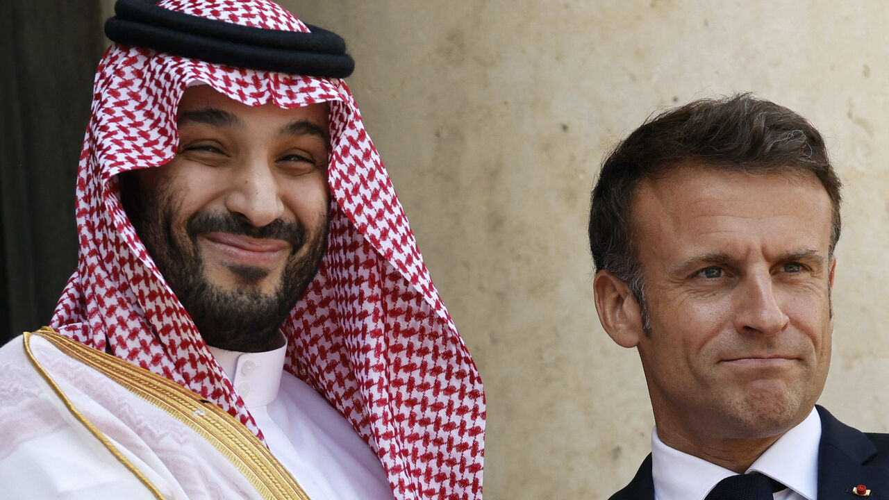 France's President Emmanuel Macron greets Saudi Crown Prince Mohammed bin Salman as he arrives at presidential Elysee Palace in Paris, on June 16, 2023.