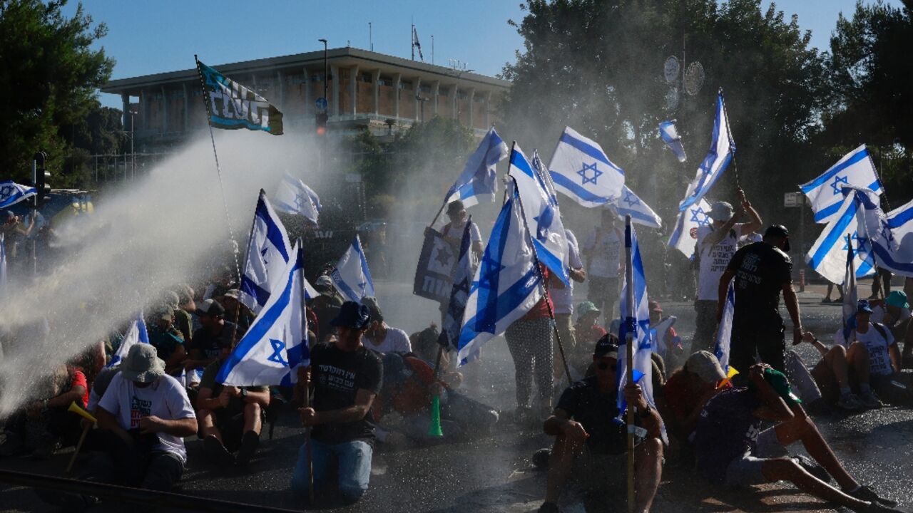 Israeli security forces used water cannon to disperse protesters blocking the entrance to parliament Israeli security forces used water cannon to disperse protesters blocking the entrance to parliament