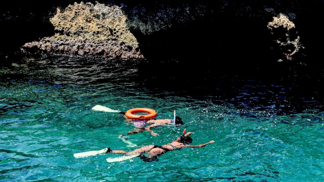 Bathers in the Mediterranean off the village of Kfarabida in north Lebanon