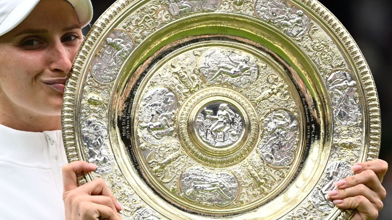 Champion: Marketa Vondrousova celebrates as she kisses the Venus Rosewater Dish trophy 