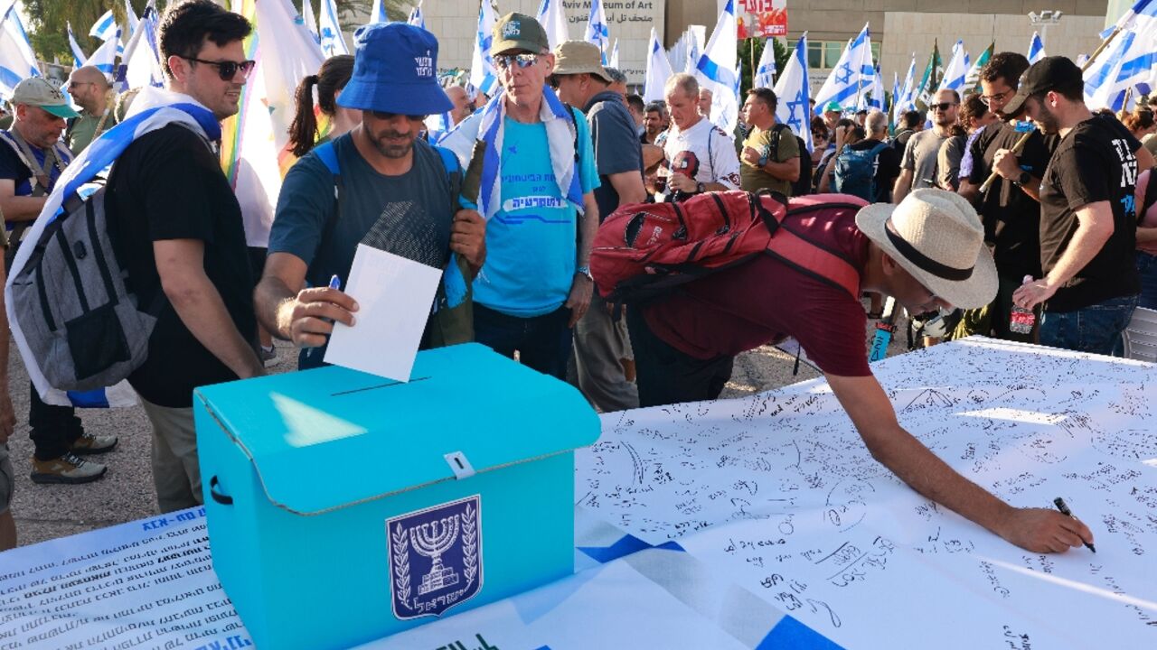 Military reservists sign a declaration announcing the suspension of their voluntary reserve duty as part of the protest