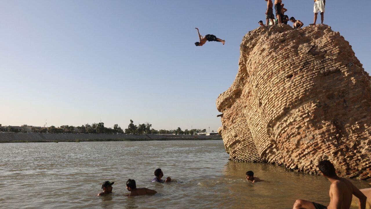 An Iraqi dives into the waters of the Tigris river in Baghdad on July 12, 2023, as temperatures soared past 45 degrees Celsius An Iraqi dives into the waters of the Tigris river in Baghdad on July 12, 2023, as temperatures soared past 45 degrees Celsius