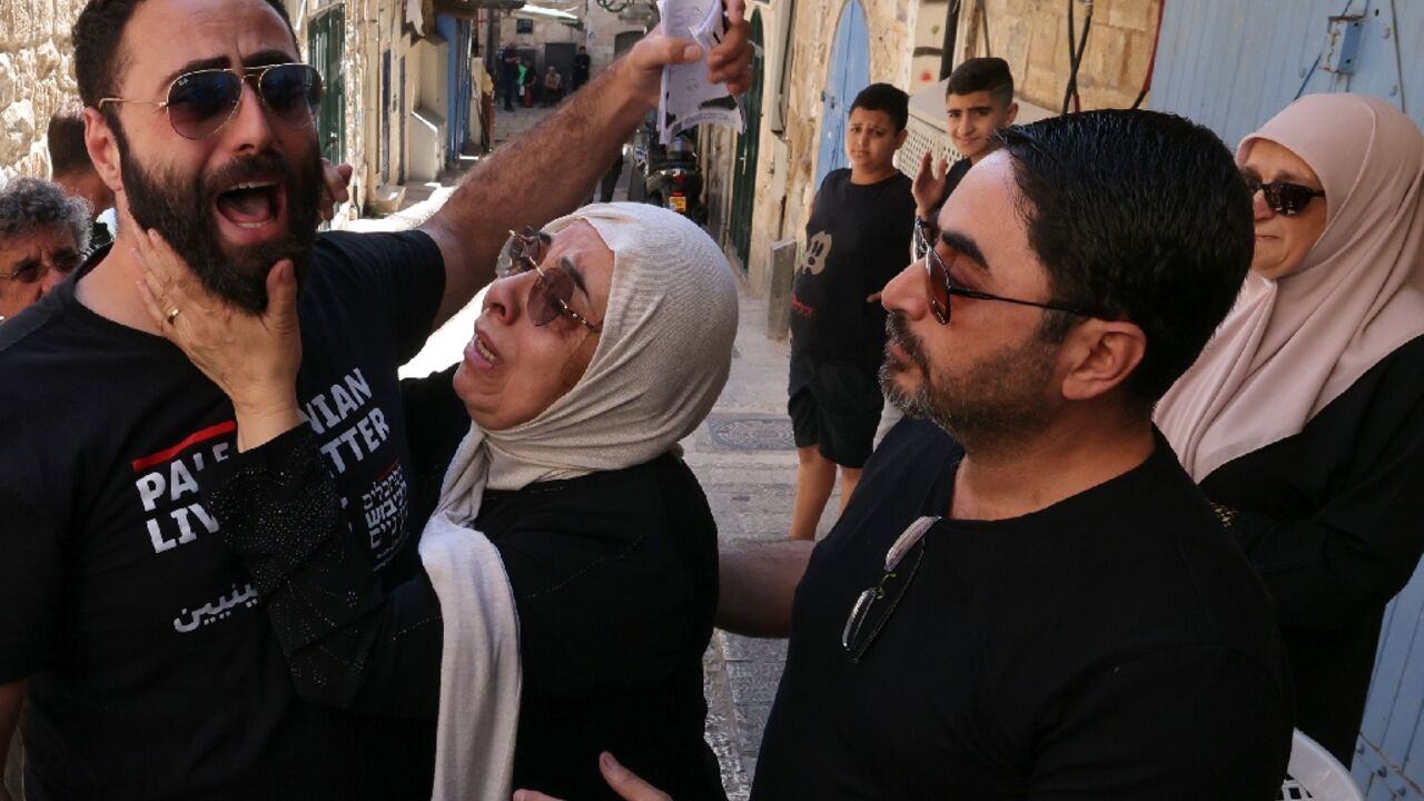 Nora Sub Laban (C) and her sons Raafat (L) and Ahmad after their eviction Nora Sub Laban (C) and her sons Raafat (L) and Ahmad after their eviction