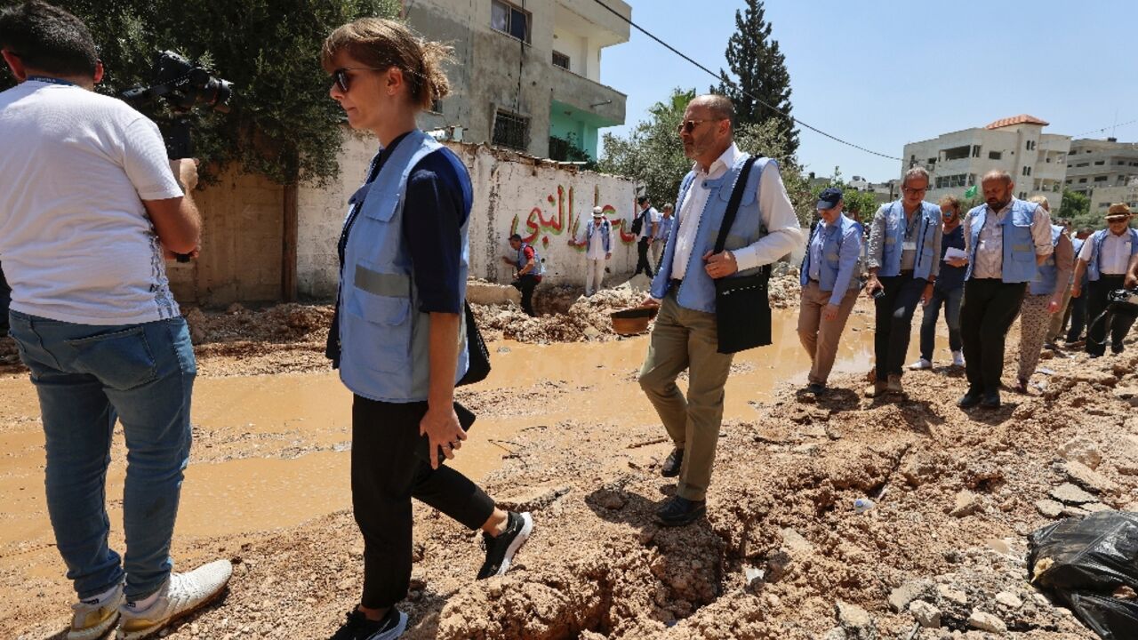 Members of an international delegation tour the Jenin camp for Palestinian refugees