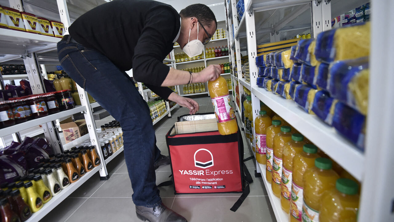 An employee prepares a basket of groceries at the storage department of the Algerian delivery company Yassir, in the capital Algiers on February 23, 2022. - It's the Algerian start-up that made good: despite the country's notoriously complex business climate, taxi and home-delivery firm Yassir has millions of users and is expanding across Africa. (Photo by RYAD KRAMDI / AFP) (Photo by RYAD KRAMDI/AFP via Getty Images)