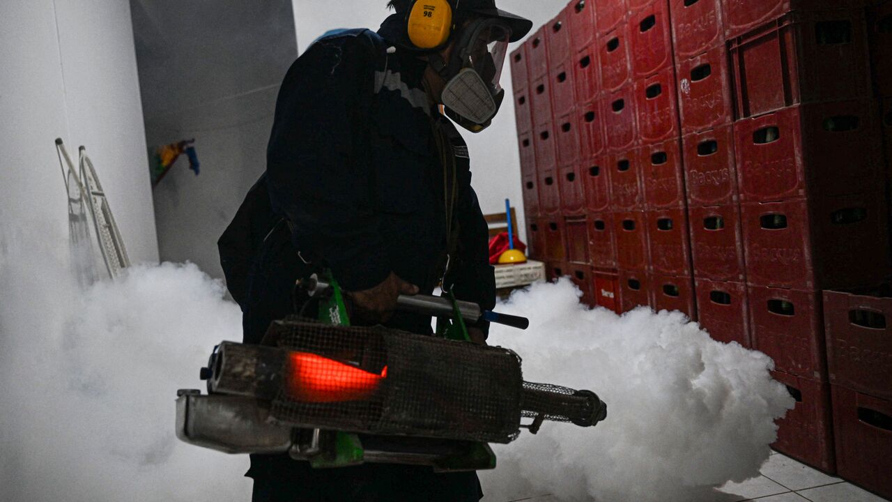 A worker fumigates a house against the Aedes aegypti mosquito to prevent the spread of dengue fever in a neighborhood in Piura, northern Peru, on June 11, 2023. (Photo by ERNESTO BENAVIDES / AFP) (Photo by ERNESTO BENAVIDES/AFP via Getty Images)