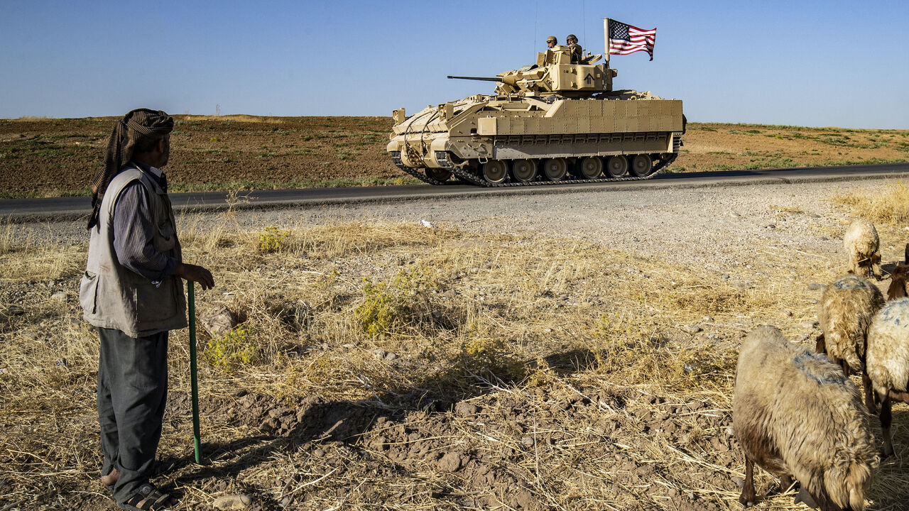 US soldiers in a Bradley Fighting Vehicle (BFV) patrol the countryside of al-Malikiya town (Derik in Kurdish) in Syria's northeastern Hasakah province July 17, 2023. (Photo by Delil SOULEIMAN / AFP) (Photo by