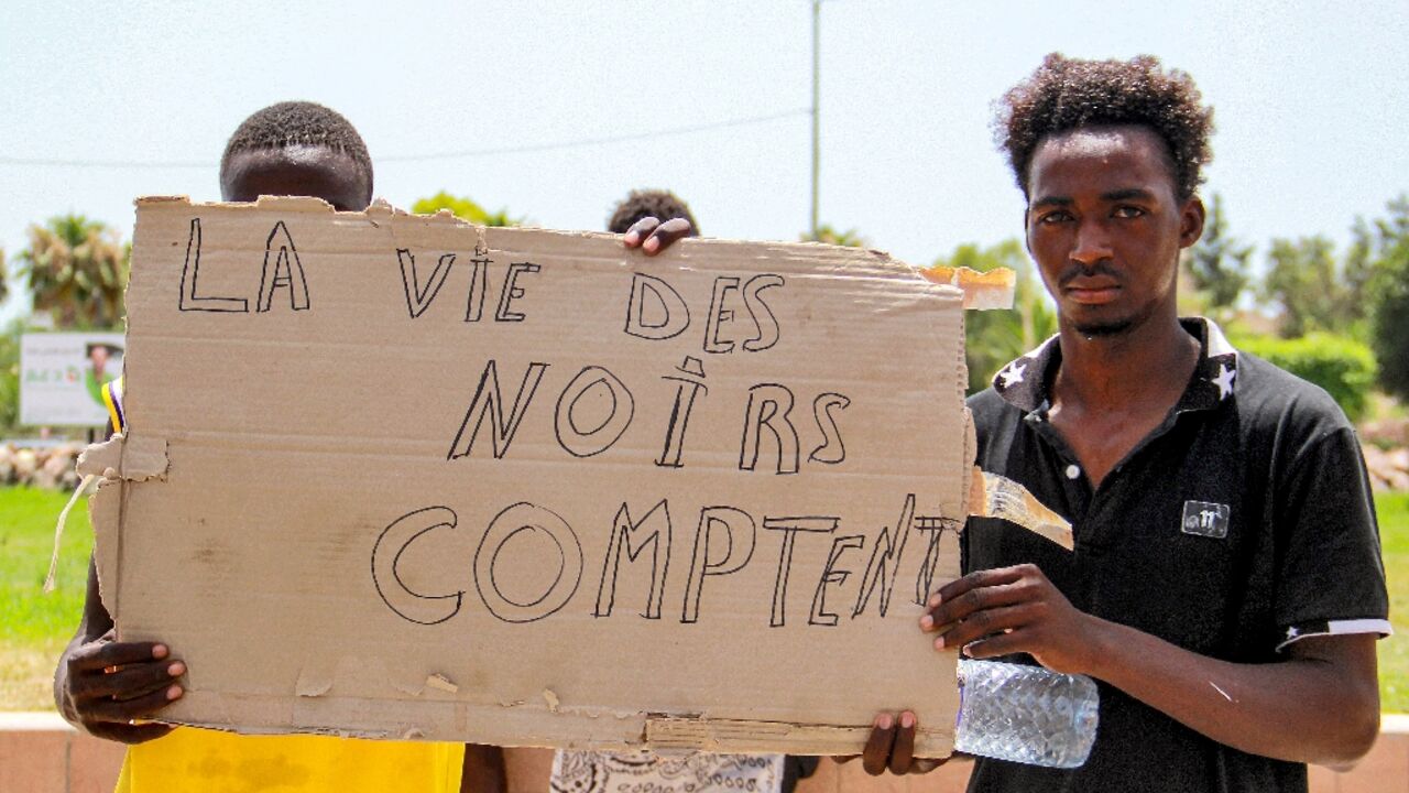 Migrants display the slogan "Black Lives Matter" in French at a protest in Sfax Migrants display the slogan "Black Lives Matter" in French at a protest in Sfax