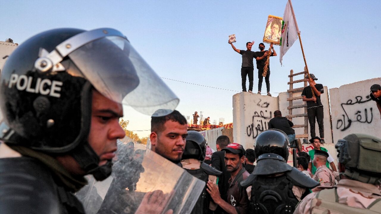 Iraqi riot police try to disperse protesters who breached the Swedish embassy compound and set fires inside Iraqi riot police try to disperse protesters who breached the Swedish embassy compound and set fires inside
