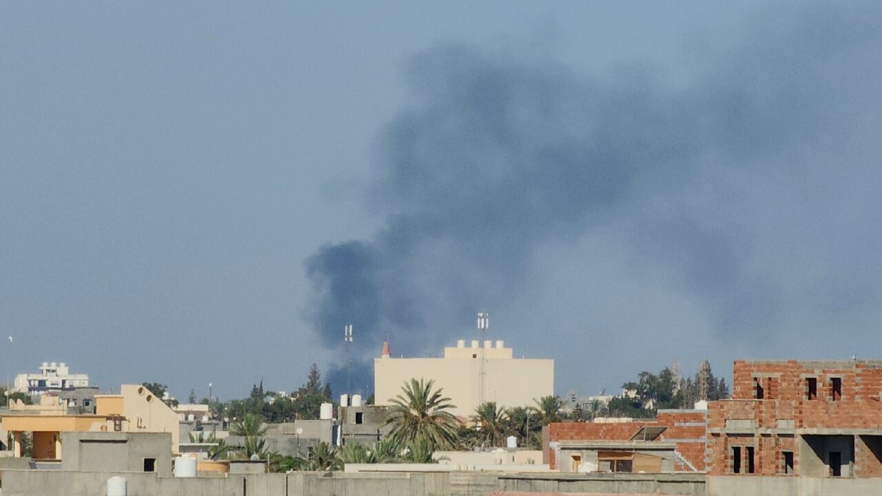 Smoke billows over the Libyan capital amid heavy fighting between the two main armed groups linked to the Tripoli-based government