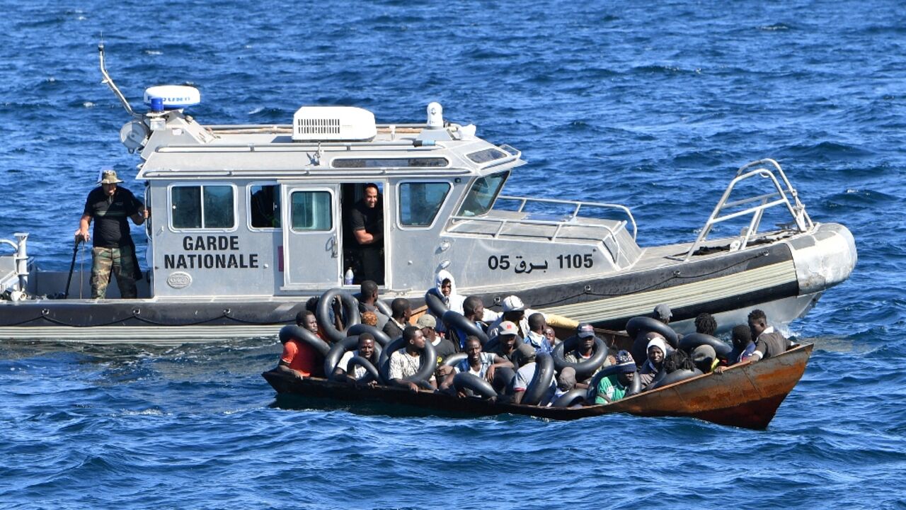 Tunisian coastguard officers intercept a migrants boat at sea, on August 10 Tunisian coastguard officers intercept a migrants boat at sea, on August 10