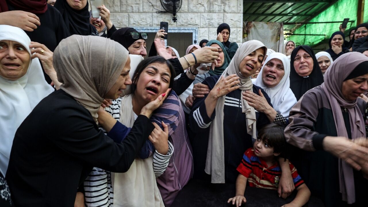 Women cry at the funeral of 18-year-old Palestinian Mahmoud Abu Saan who was shot and killed by Israeli forces in the occupied West Bank Women cry at the funeral of 18-year-old Palestinian Mahmoud Abu Saan who was shot and killed by Israeli forces in the occupied West Bank