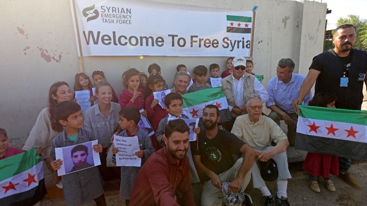 The members of Congress pose with orphaned children at a hospital in Syria's border town of Azaz The members of Congress pose with orphaned children at a hospital in Syria's border town of Azaz