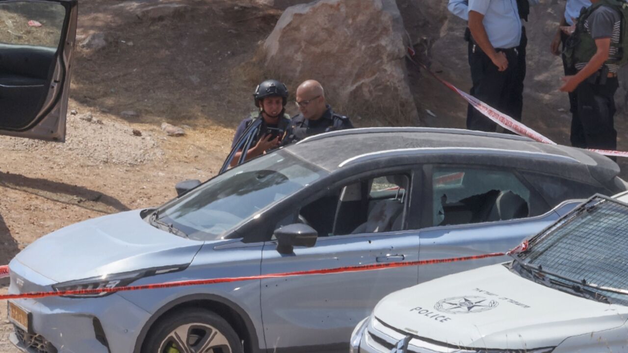 Members of Israeli security forces and emergency services stand at the site of a reported attack south of Hebron in the occupied West Bank Members of Israeli security forces and emergency services stand at the site of a reported attack south of Hebron in the occupied West Bank
