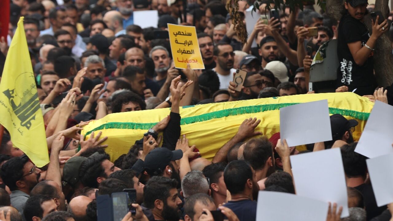 People carry the body of a fighter of the Lebanese Hezbollah movement during his funeral after he was killed in clashes People carry the body of a fighter of the Lebanese Hezbollah movement during his funeral after he was killed in clashes