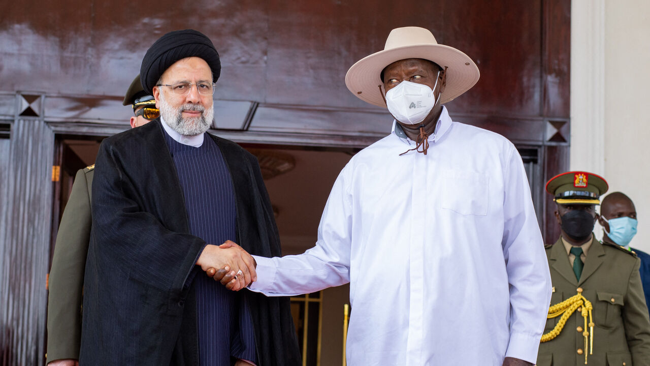 Iranian President Ebrahim Raisi (L) and Ugandan President Yoweri Museveni (R) shake hands during his state visit to Uganda at the State House in Entebbe, Uganda, on July 12, 2023. (Photo by BADRU KATUMBA / AFP) (Photo by BADRU KATUMBA/AFP via Getty Images)