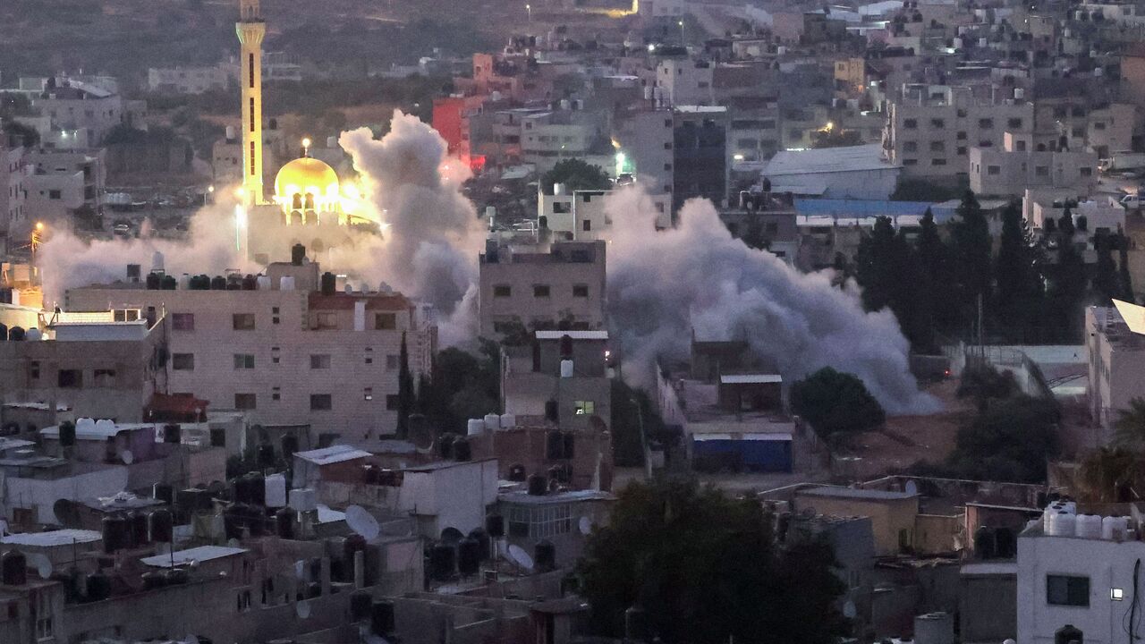 Smoke billows as Israeli soldiers demolish a house at the Asker camp for Palestinian refugees east of Nablus city in the occupied West Bank, early on August 8, 2023. The Israeli army demolished the house of Abdel Fatah Khroushah accused of an attack which killed two Israelis in the occupied West Bank at the end of February. (Photo by Jaafar ASHTIYEH / AFP) (Photo by JAAFAR ASHTIYEH/AFP via Getty Images)