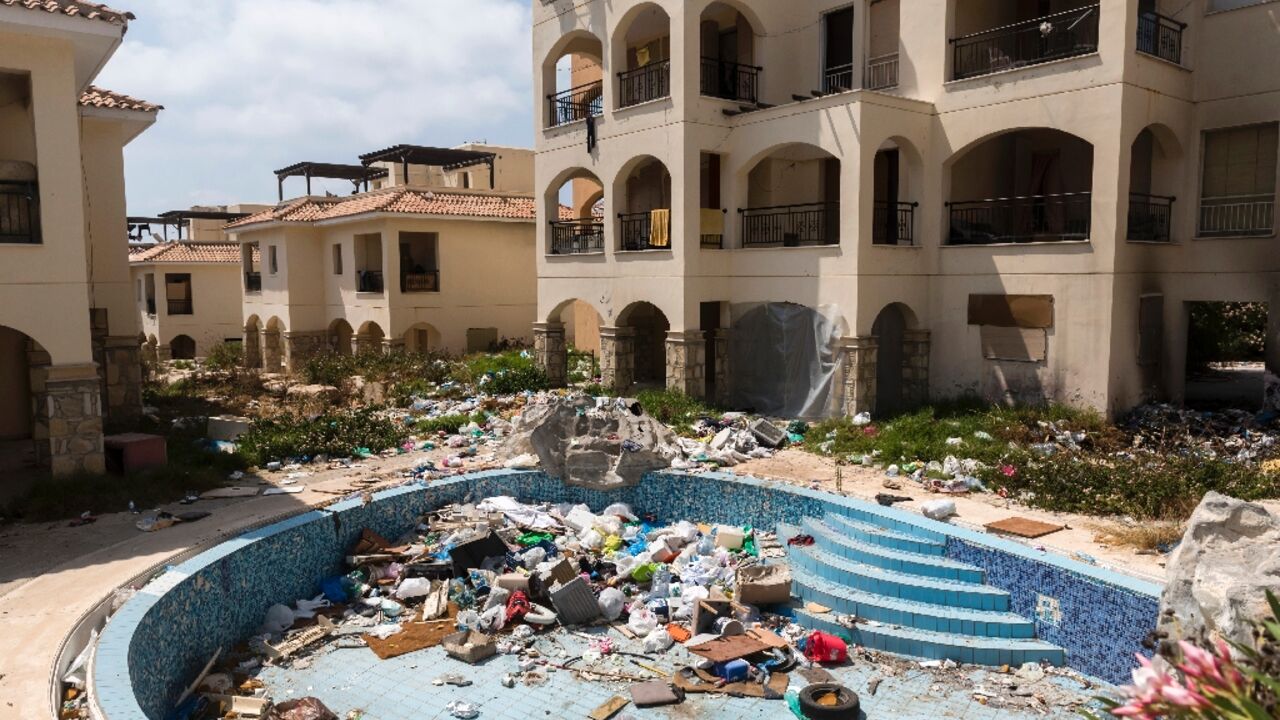 A swimming pool is filled with garbage at the Ayios Nikolaos apartment complex A swimming pool is filled with garbage at the Ayios Nikolaos apartment complex
