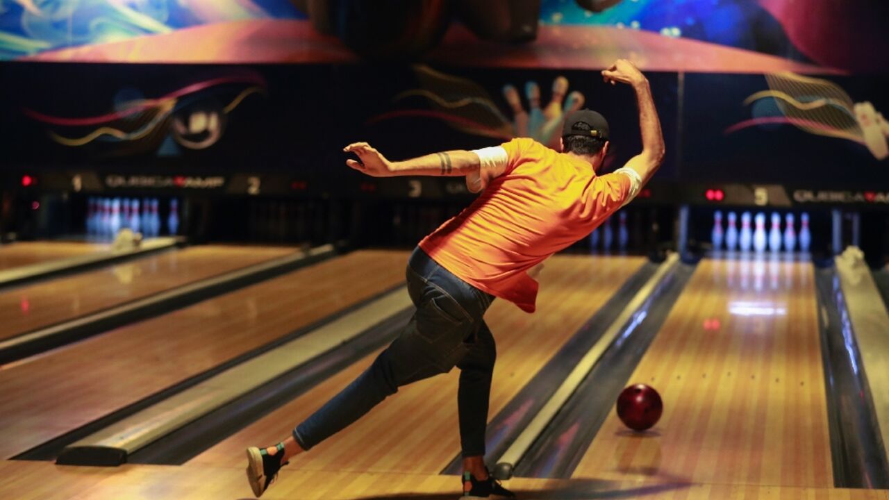An Iraqi delivers a ball at a bowling alley in Baghdad An Iraqi delivers a ball at a bowling alley in Baghdad