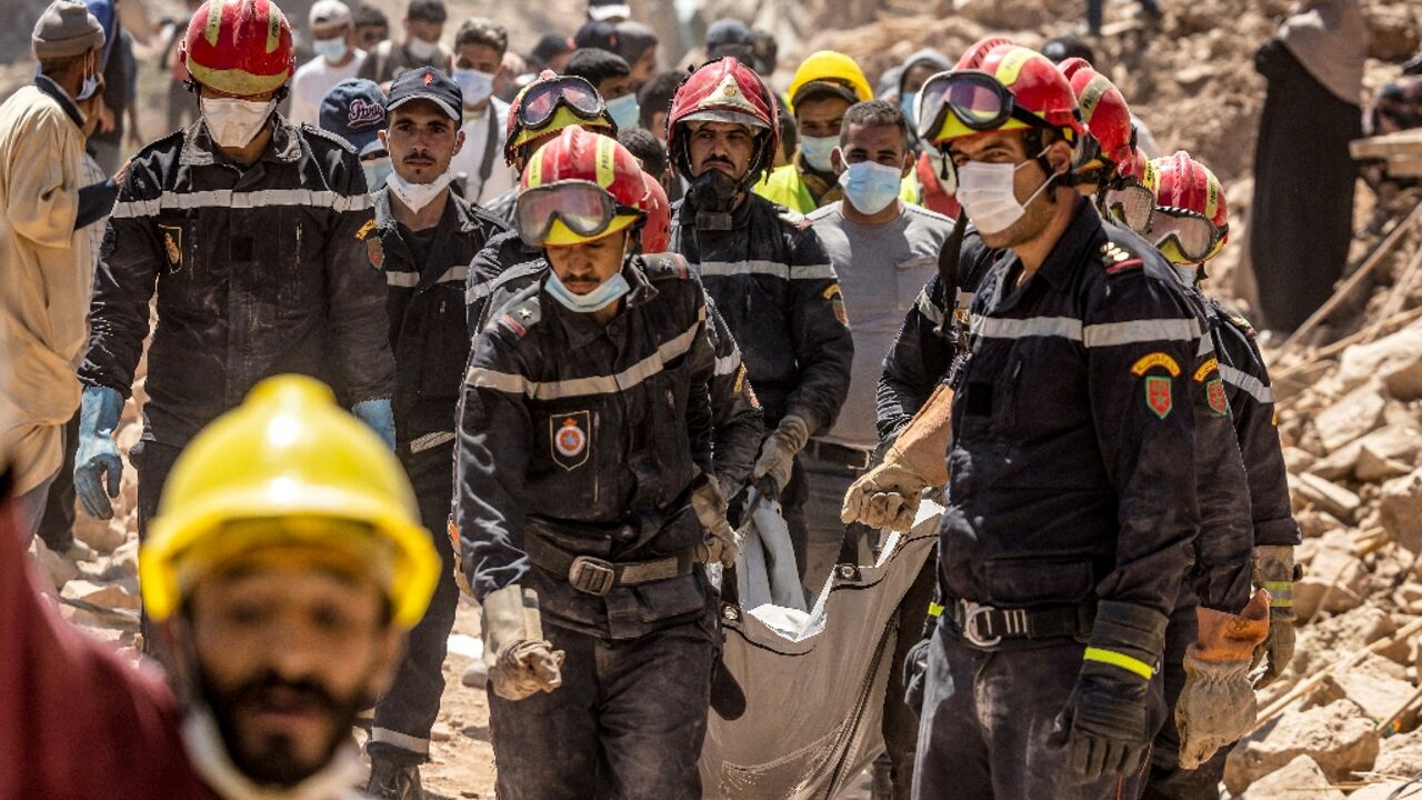 Rescue workers carry a body recovered from the rubble of an earthquake-damaged house in Morocco Rescue workers carry a body recovered from the rubble of an earthquake-damaged house in Morocco