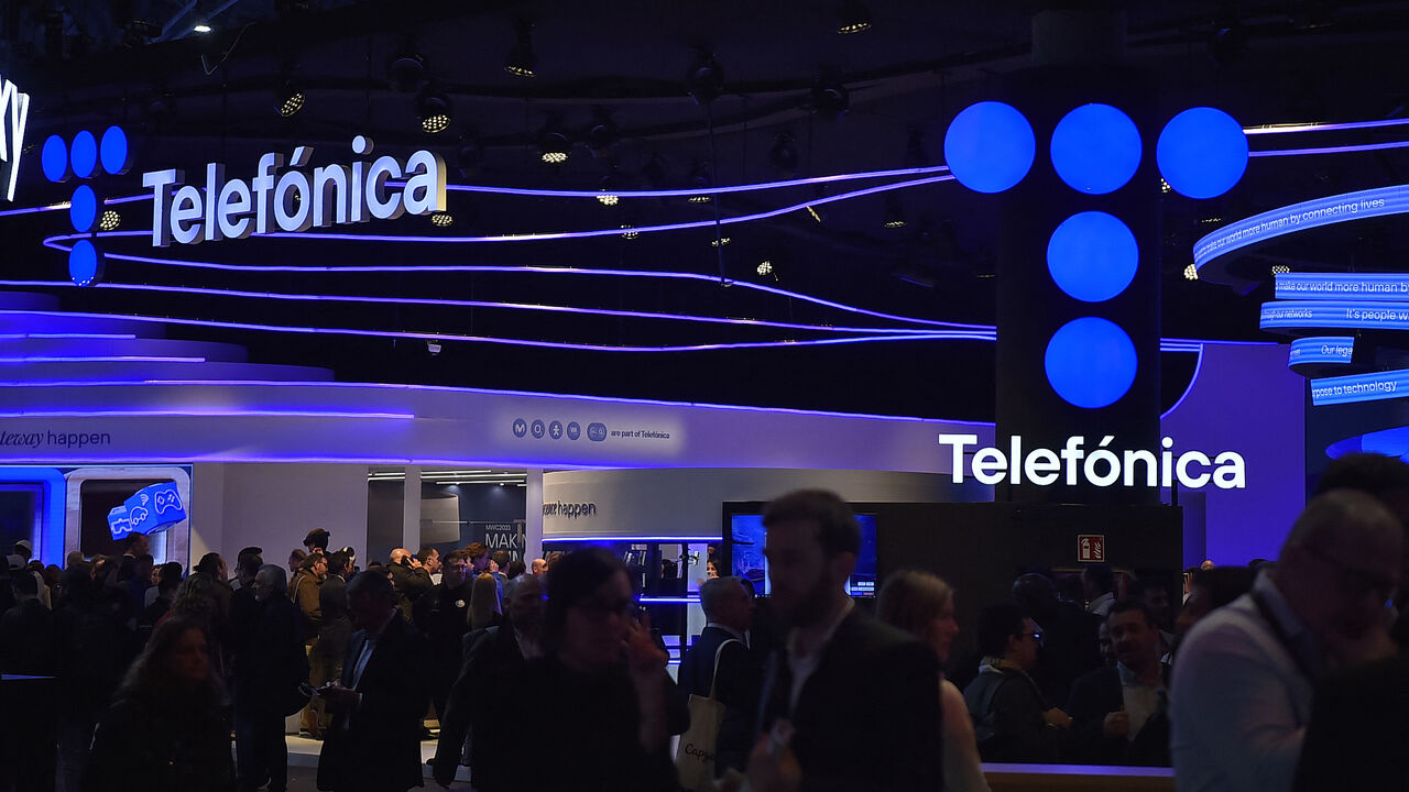 People visit the stand of Spanish company Telefonica at the Mobile World Congress (MWC), the telecom industry's biggest annual gathering, in Barcelona on February 27, 2023. (Photo by Pau BARRENA / AFP) (Photo by PAU BARRENA/AFP via Getty Images)