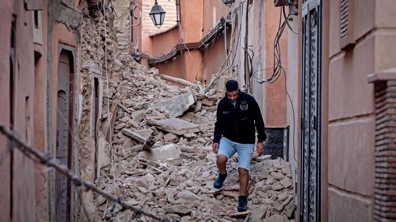 A resident navigates through the rubble following a 6.8-magnitude quake in Marrakesh on September 9, 2023. A powerful earthquake that shook Morocco late September 8 killed more than 600 people, interior ministry figures showed, sending terrified residents fleeing their homes in the middle of the night. (Photo by FADEL SENNA / AFP) (Photo by FADEL SENNA/AFP via Getty Images)