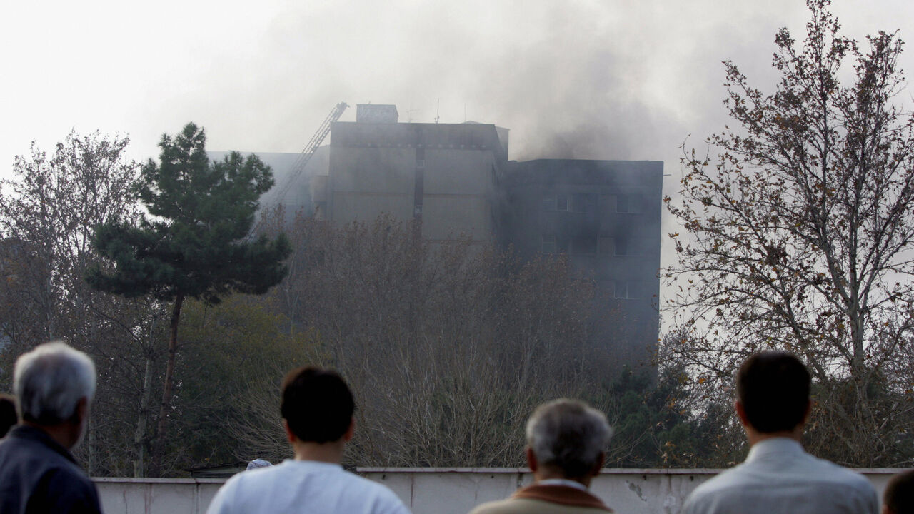 Rescue teams attend to the scene of devastation after an Iranian military plane crashed into a residential building in a heavily built-up suburb on December 6, 2005 in Tehran, Iran. A huge explosion was reported as the plane, carrying 94 people, crashed into a 10-storey block killing all on board. Many deaths are also feared on the ground after the C-130 plane encountered a technical problem shortly after take-off from Mehrabad airport. (Photo by Hossein/Getty Images)