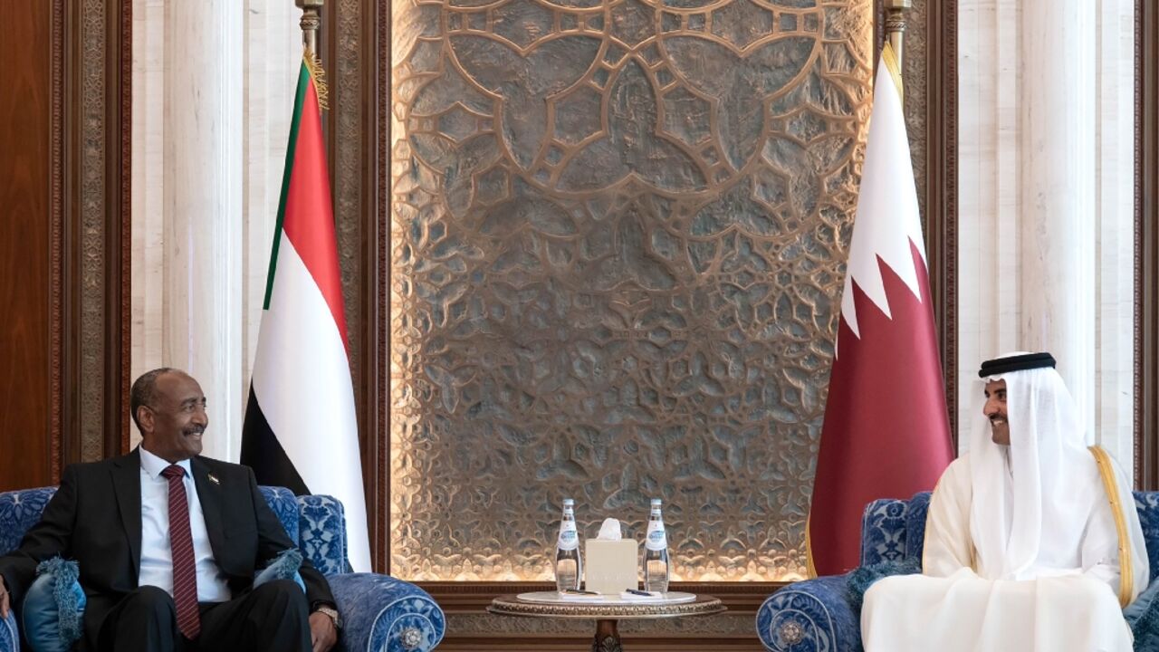Qatar's Emir Sheikh Tamim bin Hamad Al Thani (R) meets with Sudan's army chief Abdel Fattah al-Burhan in Doha Qatar's Emir Sheikh Tamim bin Hamad Al Thani (R) meets with Sudan's army chief Abdel Fattah al-Burhan in Doha