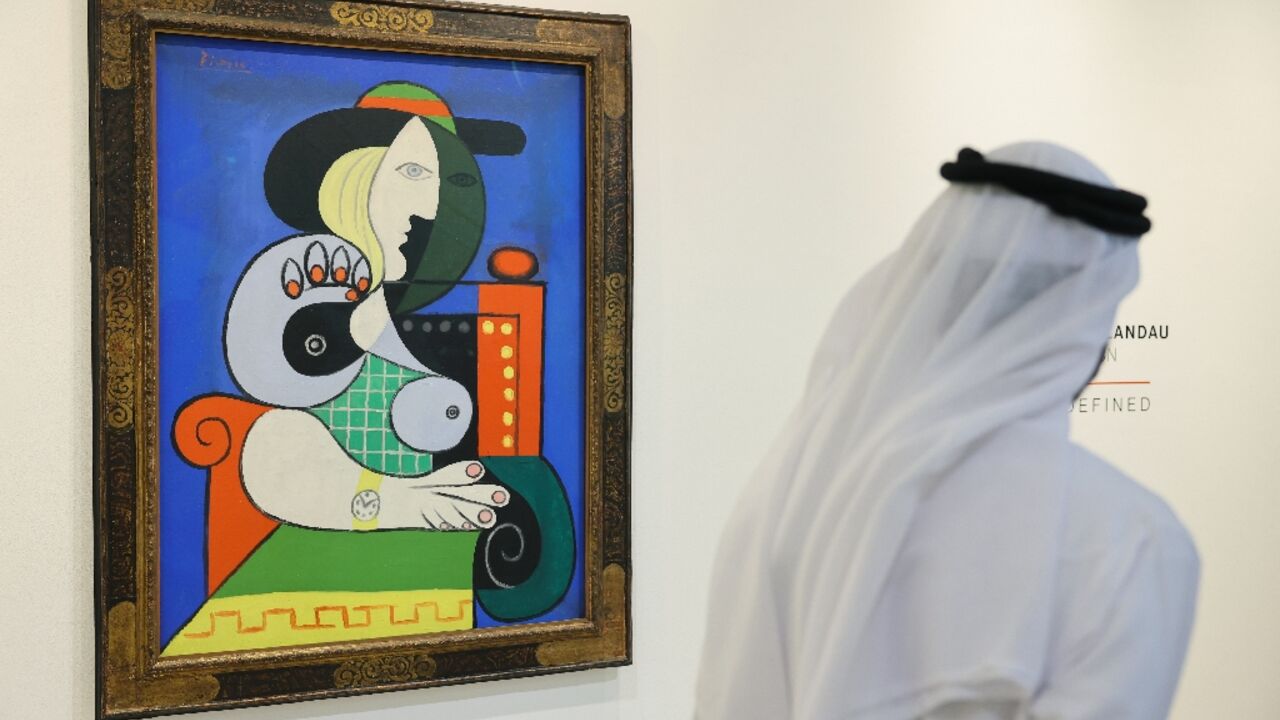 A visitor looks at Pablo Picasso's painting 'Femme a la montre' displayed for viewing at Sotheby’s Dubai, ahead of an auction in New York A visitor looks at Pablo Picasso's painting 'Femme a la montre' displayed for viewing at Sotheby’s Dubai, ahead of an auction in New York