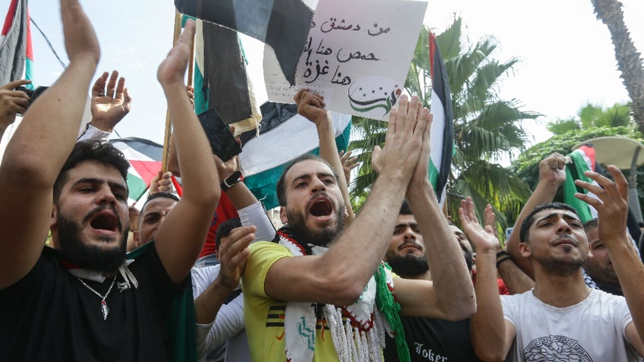 Arabs rally to praise the Palestinian 'resistance' to Israel's long-standing occupation of Palestinian land after the surprise Hamas attack on Israel