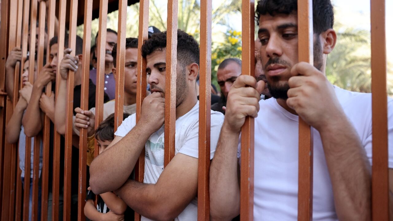 Palestinians wait outside the Nasser hospital to claim the bodies of relatives Palestinians wait outside the Nasser hospital to claim the bodies of relatives