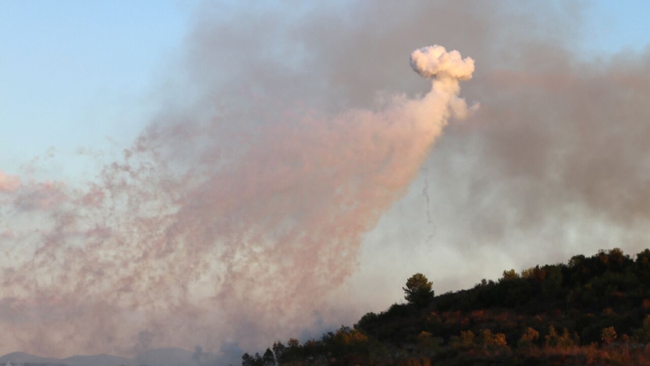 A shell fired by Israeli artillery explodes over the Lebanese village of Dhayra near the border on Monday