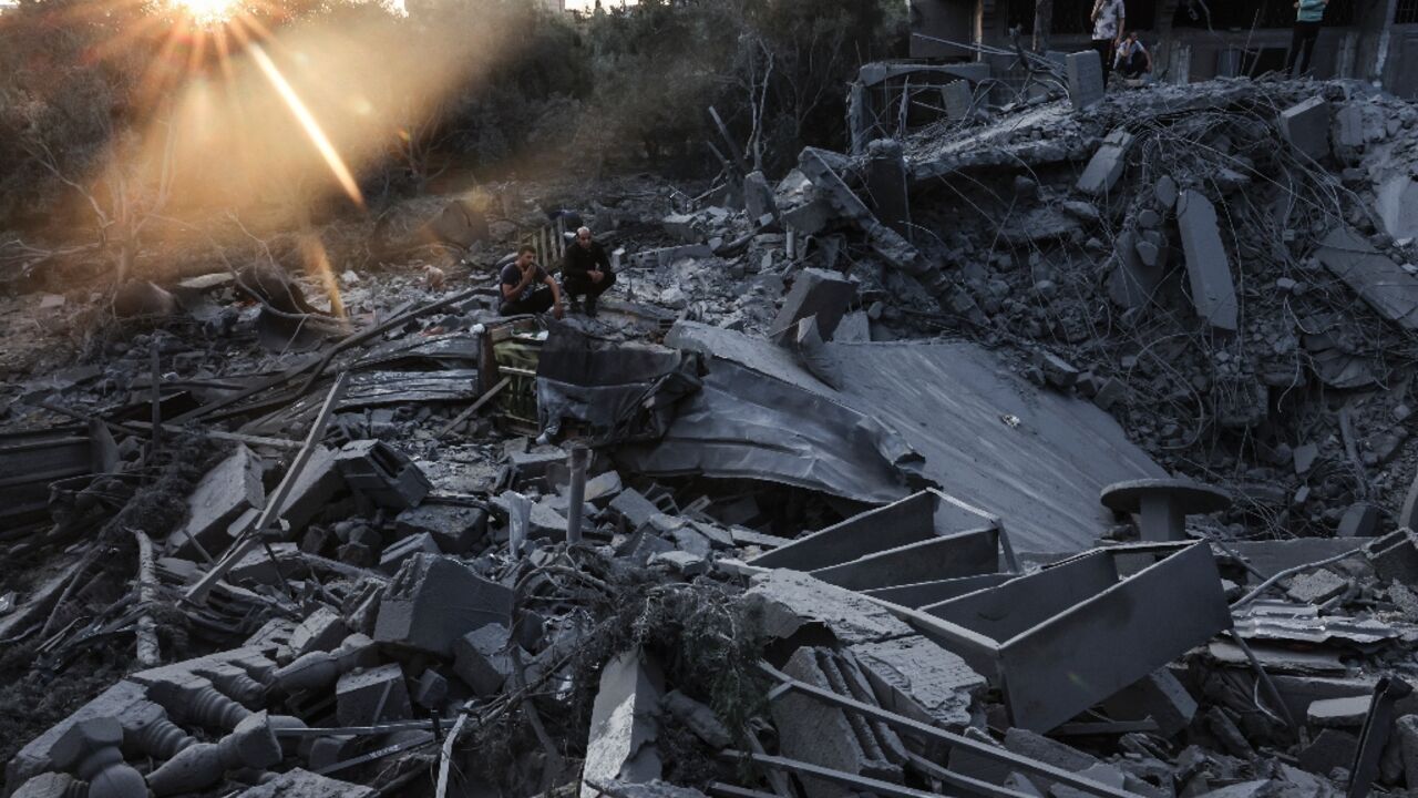 People inspect the damage to their home after Israeli strikes in the Rafah camp in southern Gaza