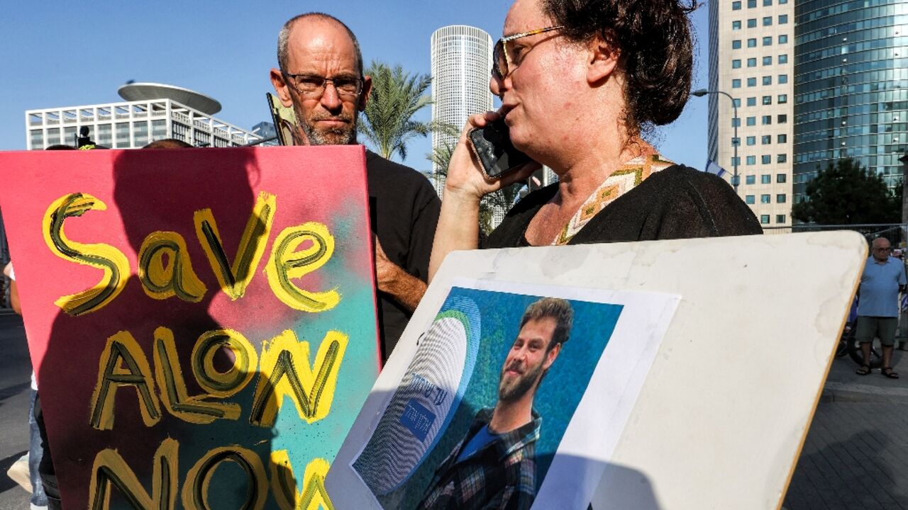 Supporters and family members of Israeli hostages, taken by the Palestinian militant group Hamas last week in a surprise attack into Israel, gather during a rally outside of the Israeli military base of HaKirya in central Tel Aviv