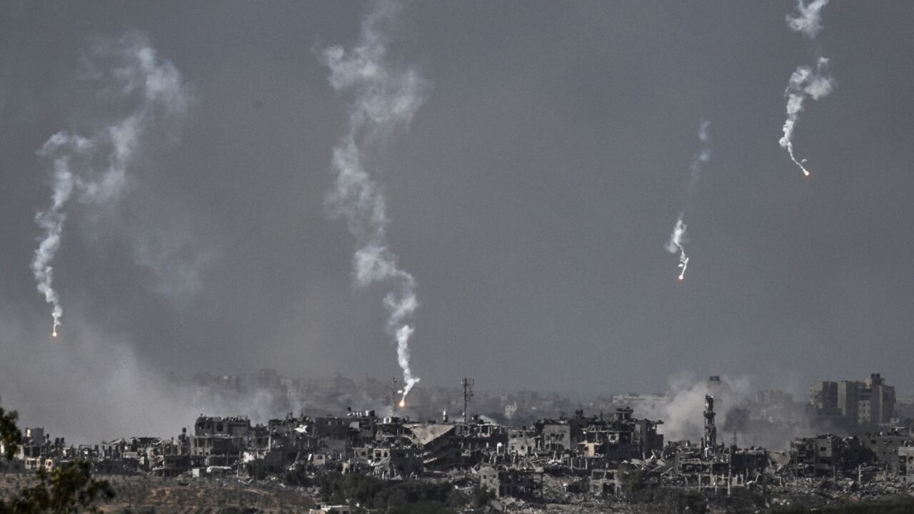 A picture taken from Israel's southern city of Sderot shows flares dropped by Israeli forces above the north of the Gaza Strip, on October 30, 2023