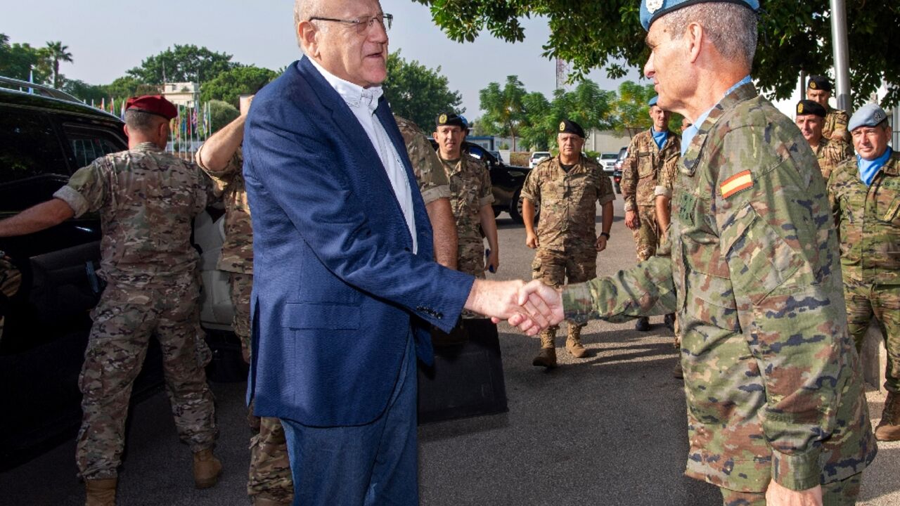 Lebanon's Najib Mikati (L) shaking hands with UNIFIL chief Aroldo Lazaro in southern Lebanon near the Israeli border Lebanon's Najib Mikati (L) shaking hands with UNIFIL chief Aroldo Lazaro in southern Lebanon near the Israeli border